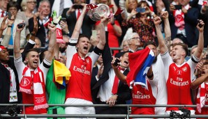 Arsenal-Kapitän Per Mertesacker stemmt den Cup in den Londoner Himmel