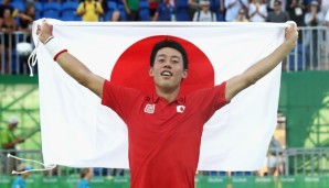 RIO DE JANEIRO, BRAZIL - AUGUST 14: (EDITORS NOTE: Retransmission with alternate crop.) Kei Nishikori of Japan celebrates with the Japanese flag after winning the singles bronze medal match against Rafael Nadal of Spain on Day 9 of the Rio 2016 Olym...