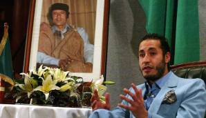 Al-Saadi al-Gaddafi vor einem Foto seines Vaters Muammar al-Gaddafi, dem langjährigen Diktator Libyens.