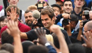 Roger Federer begrüßt die Fans und die versammelte Presse beim traditionellen Fotoshooting am Folgetag des Triumphs.